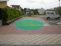 タイル張りのスペースに、緑色の楕円形の枠が表示されている写真