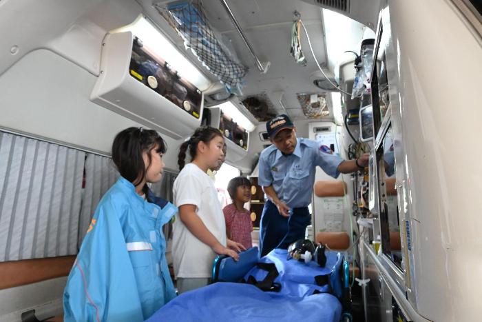 子供たちが救急車内に乗り、資器材の説明を受けている