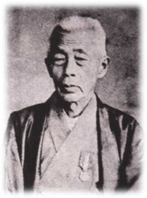 着物を着てやや下に目線を向けている草山貞胤の古い白黒写真