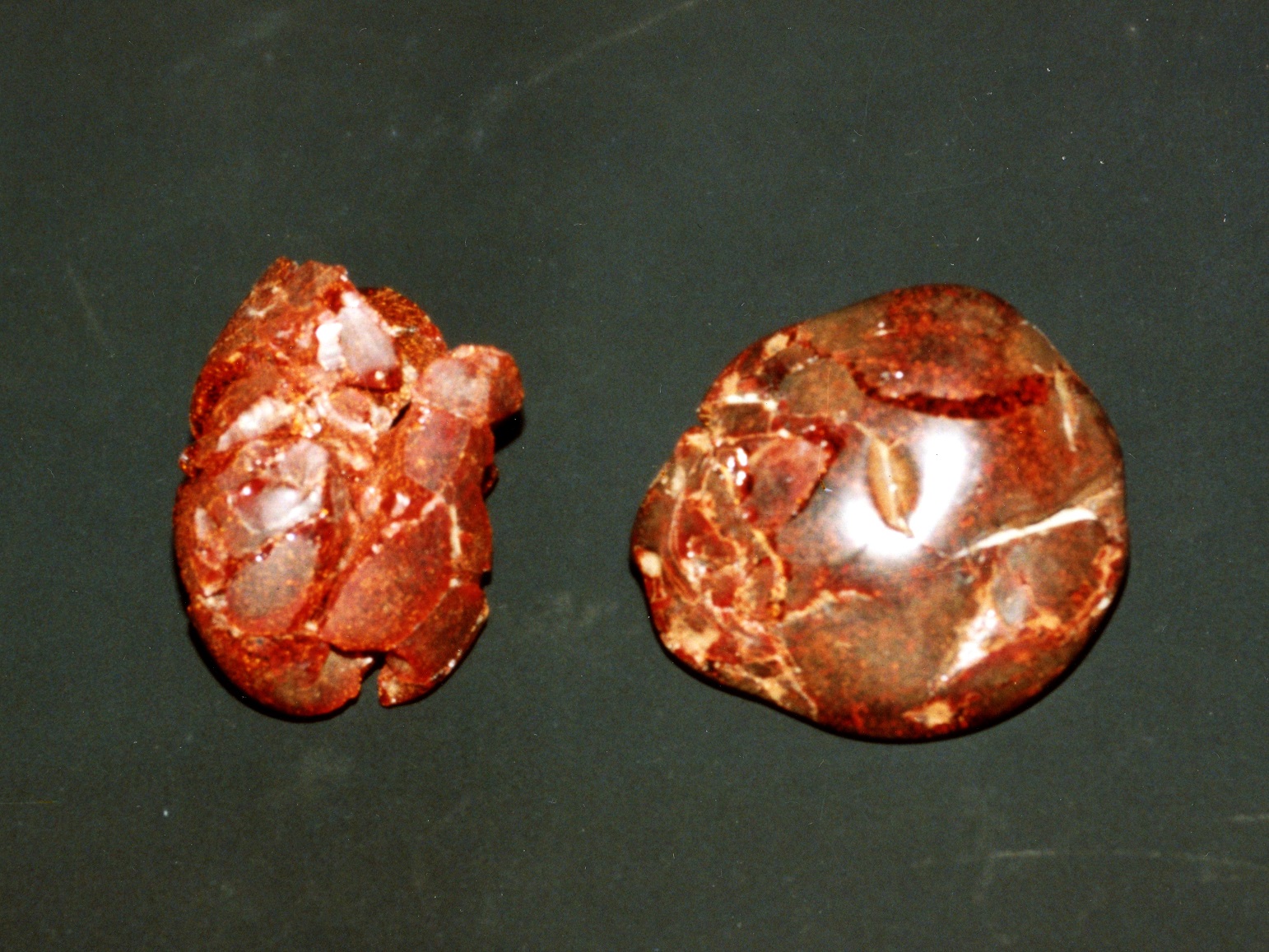 表面がひび割れた、つやのある赤茶色をした、琥珀大珠が2つ並んで置かれている写真