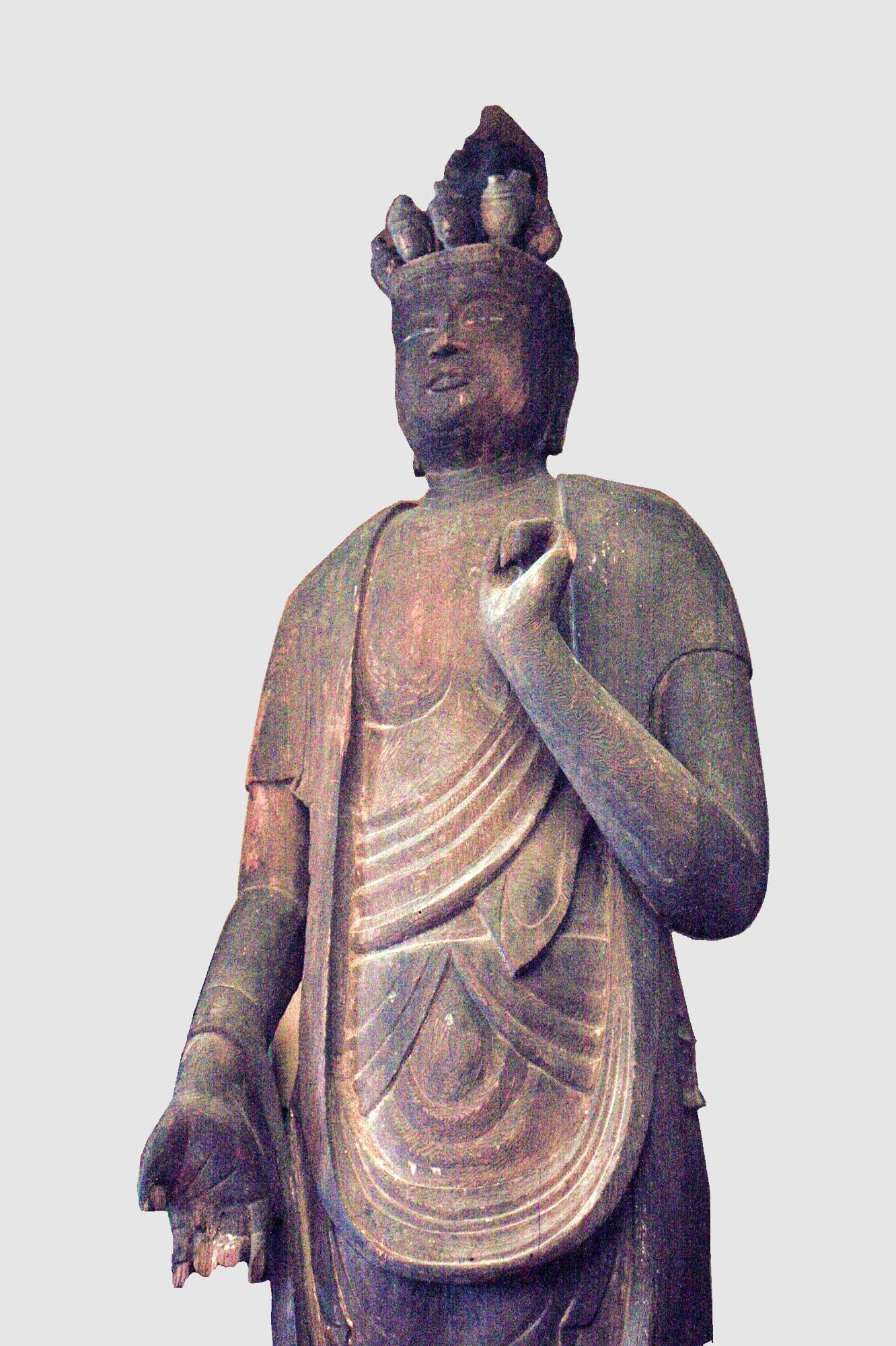 頭の上に複数の小さな頭がついた木造十一面観音菩薩立像の写真