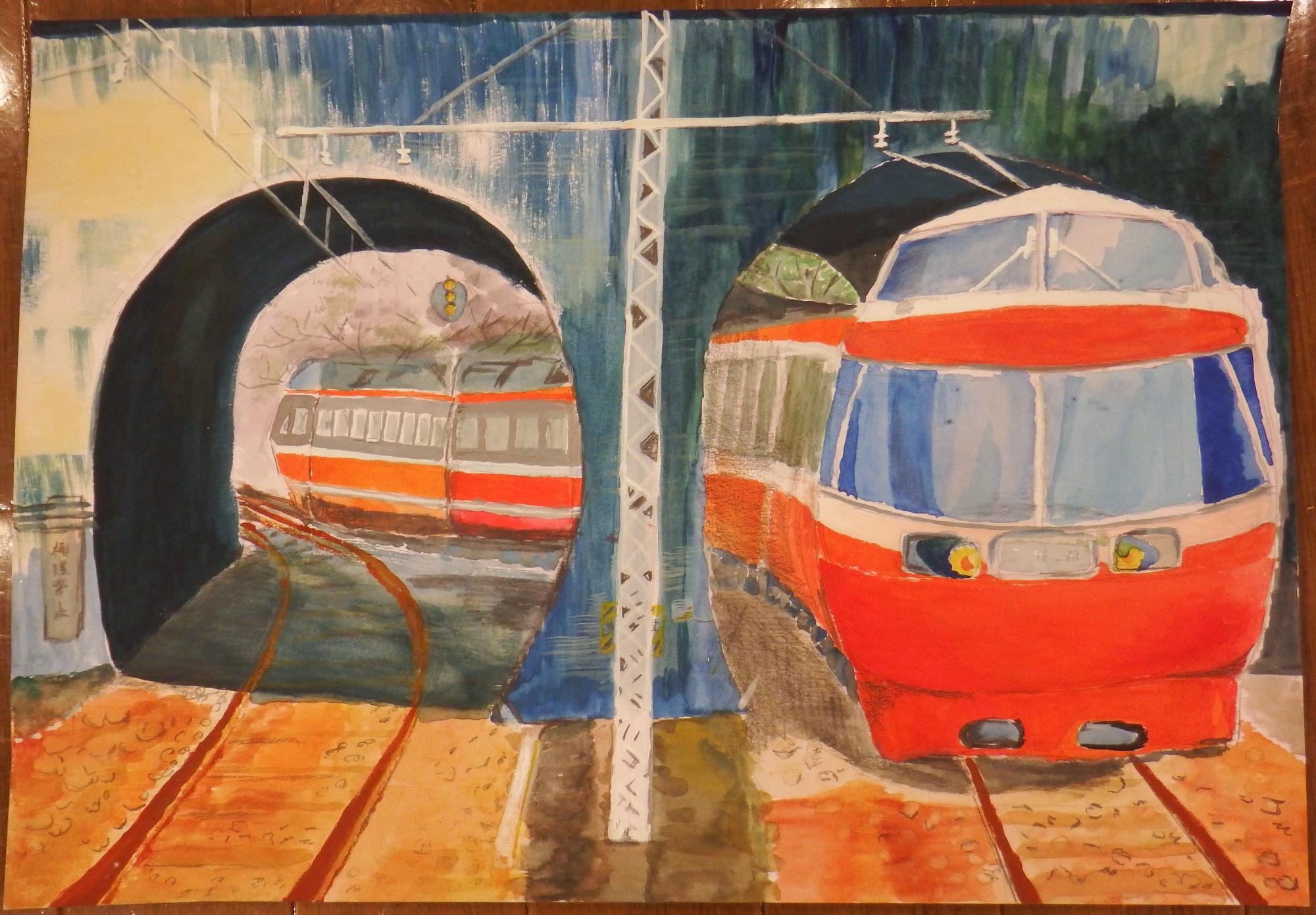 鉄道の線路や架線柱が描かれている正面に二つのトンネルがあり、右側のトンネルの奥から赤い電車が走行してきている様子を水彩画で描いた秦野市長賞受賞作品の写真