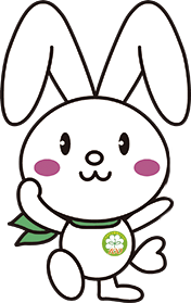 首に緑色のスカーフを巻いて、両手と右足を上げて立っている神奈川県民児協公式キャラクター「みんぴょん」のイラスト