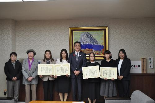 中央に市長、その左右に表彰状を持った女性4人、さらにその外側に女性3人