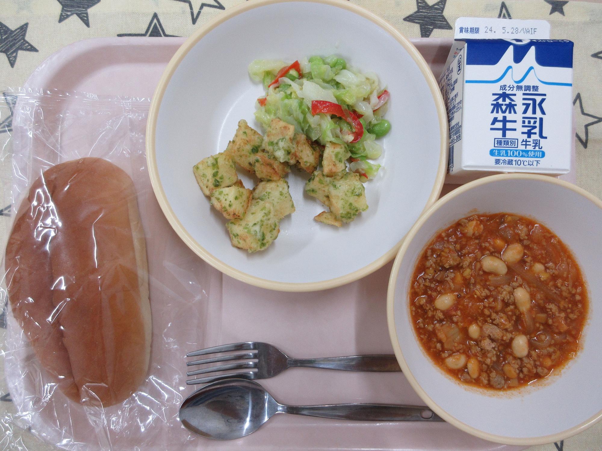 ピンクのトレーに給食が右上から反時計回りで牛乳、青のりポテトとコーンドレッシングサラダ、ソフトフランスパン 、チリコンカンと並んでいる写真