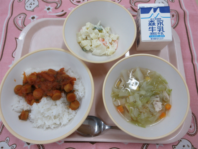 ピンクのトレーに給食が右上から反時計回りで牛乳、ポテトサラダ、ジャンバラヤ（ごはん）、キャベツのスープと並んでいる写真